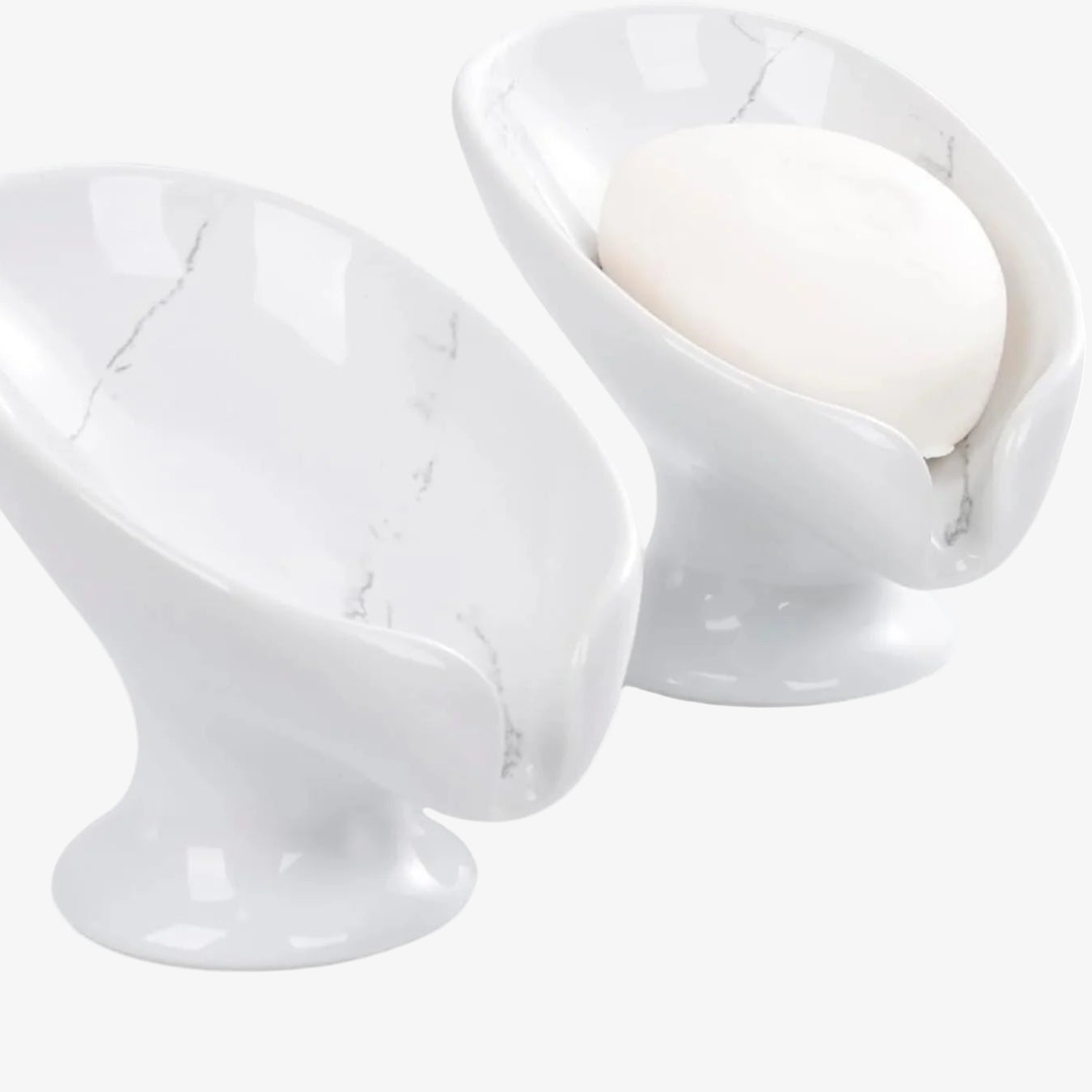 Two white marble egg holders on a white background