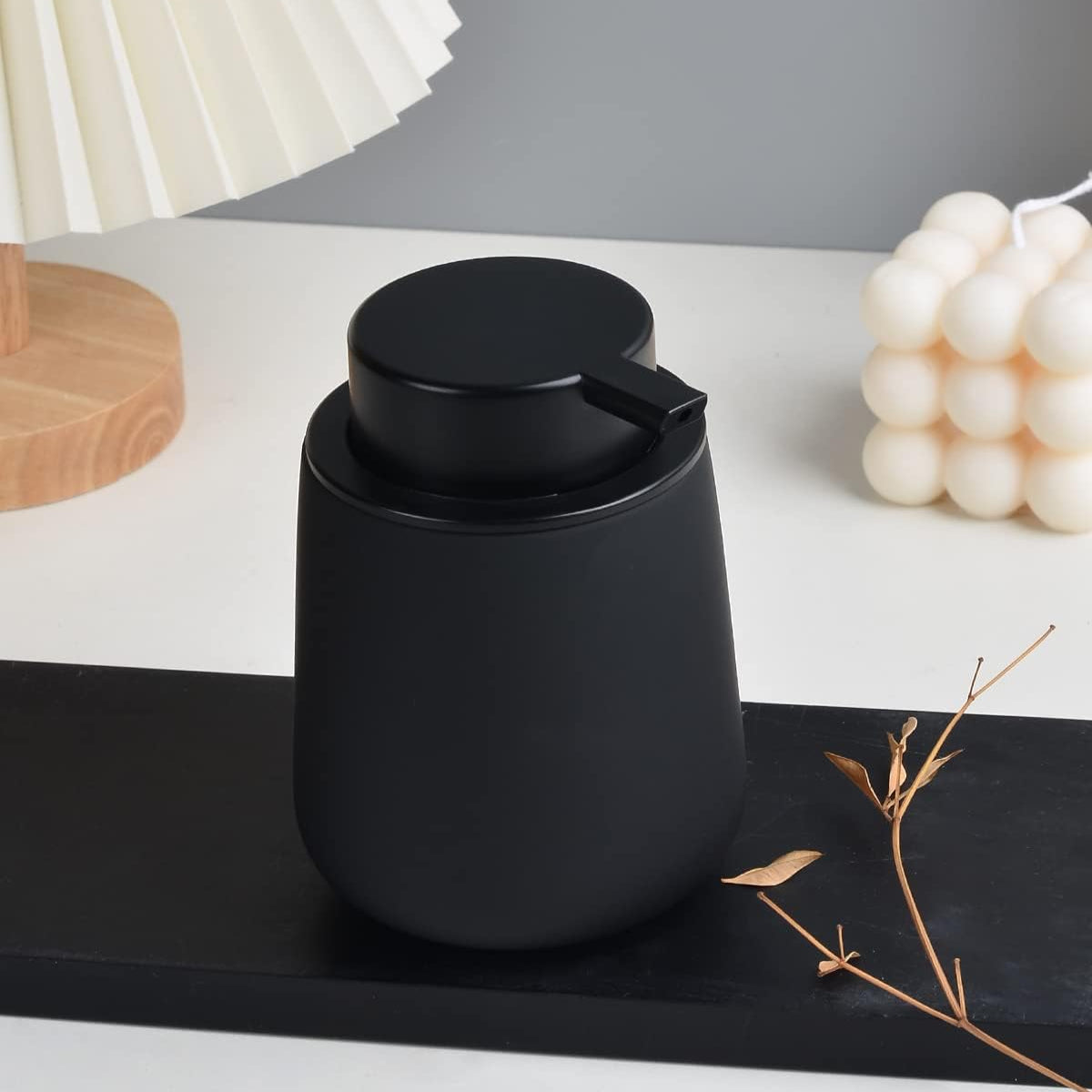 Black ceramic cup with lid on a decorative surface