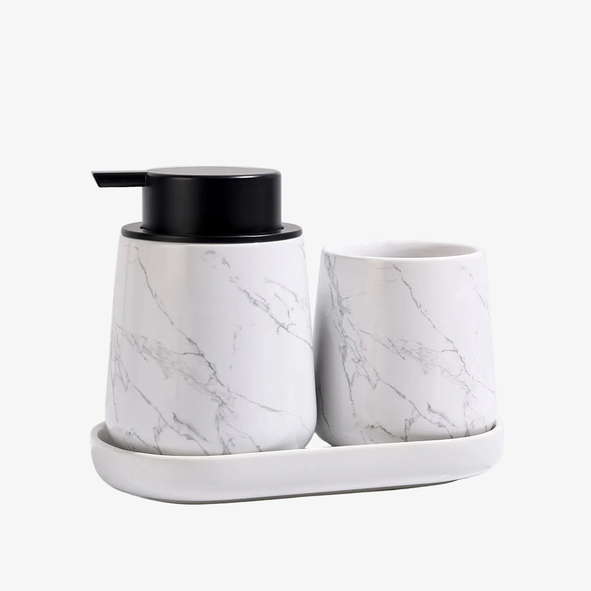 Marble-textured soap dispenser and cup set on a white background