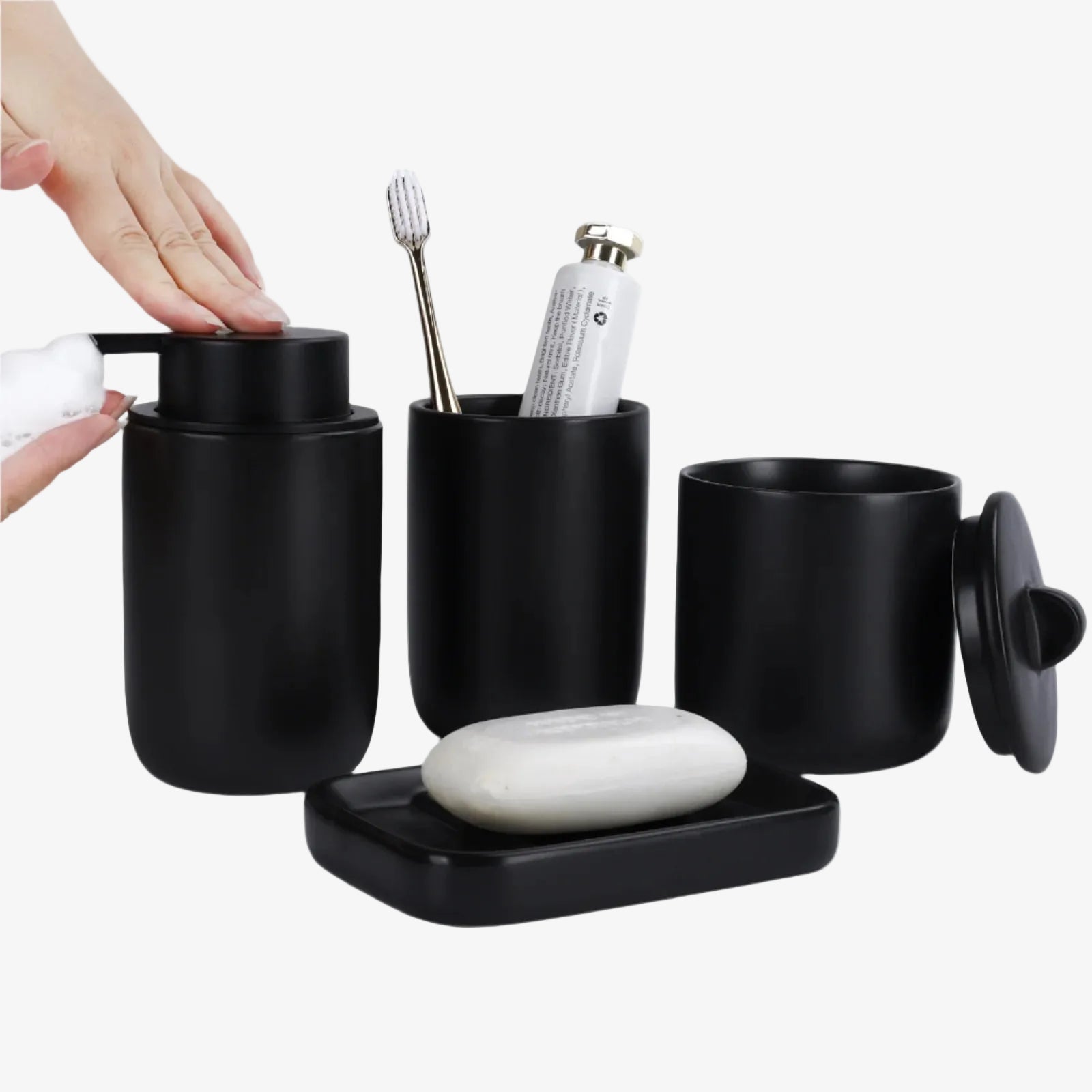 Black bathroom accessory set with toothbrush, soap, and other items on a white background