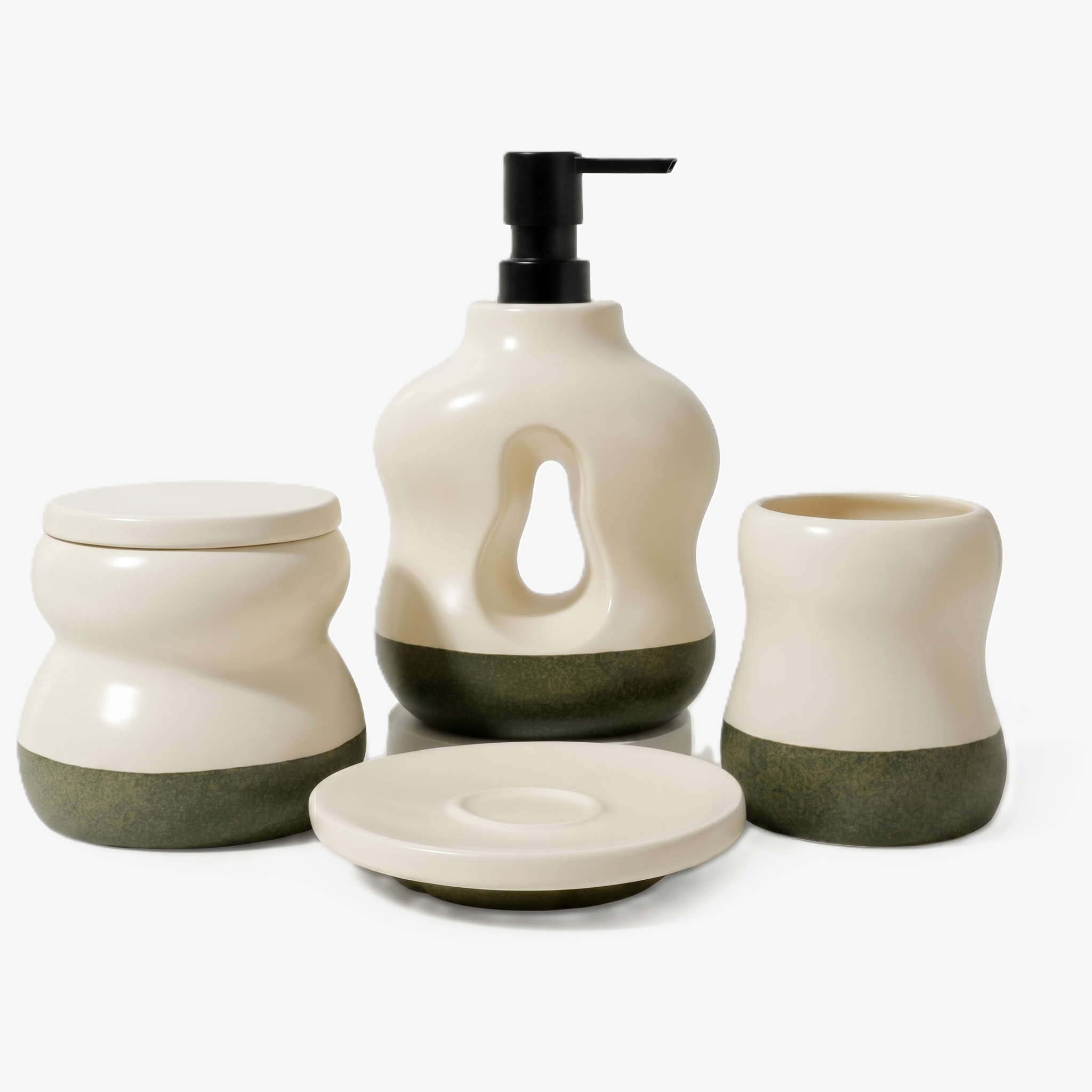 A 4-piece BosilunLife Pebblebase bathroom accessory set in a nature-inspired two-tone finish. Crafted from recycled eco-clay, the sculptural set includes a soap dispenser with a signature teardrop-shaped central cutout and matte black pump, a lidded storage jar, a toothbrush holder, and a small round tray. Each piece features a smooth ecru upper section paired with a textured, speckled moss green pebble-style base, shown against a seamless white background for an organic, sustainable washroom aesthetic.