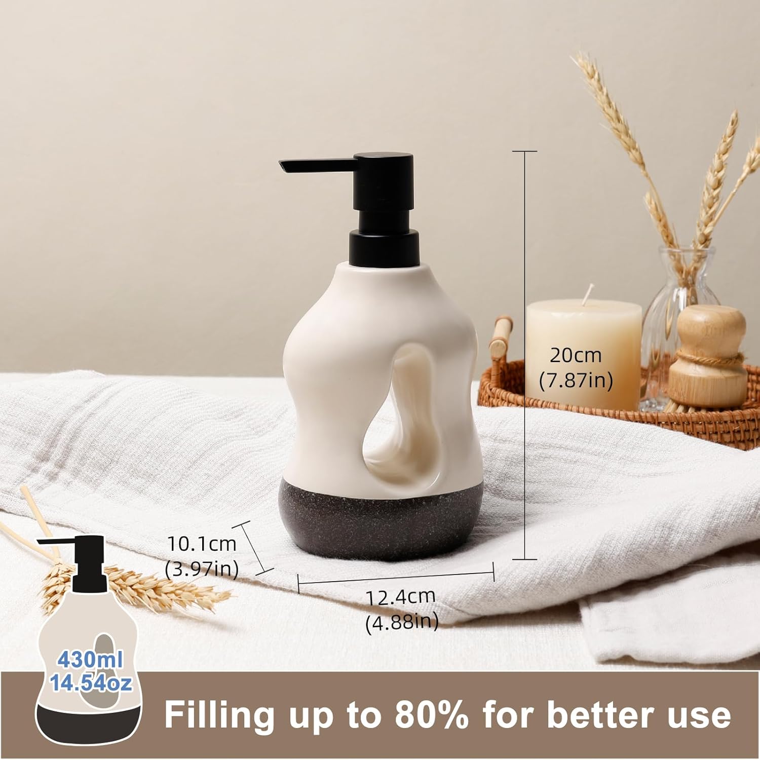 Technical dimension chart for the BosilunLife Pebblebase sculptural liquid soap dispenser in recycled eco-clay. Styled on a soft white cloth alongside a pillar candle and dried wheat, the two-tone ecru and dark speckled ceramic bottle measures 20 cm (7.87 inches) tall, 12.4 cm (4.88 inches) wide, and 10.1 cm (3.97 inches) deep. An inset graphic details a generous 430 ml (14.54 oz) capacity, accompanied by a brown text banner reading 'Filling up to 80% for better use'.