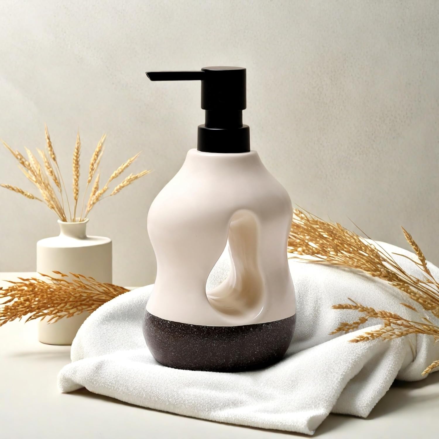 White and black bottle with pump on a white surface with decorative elements