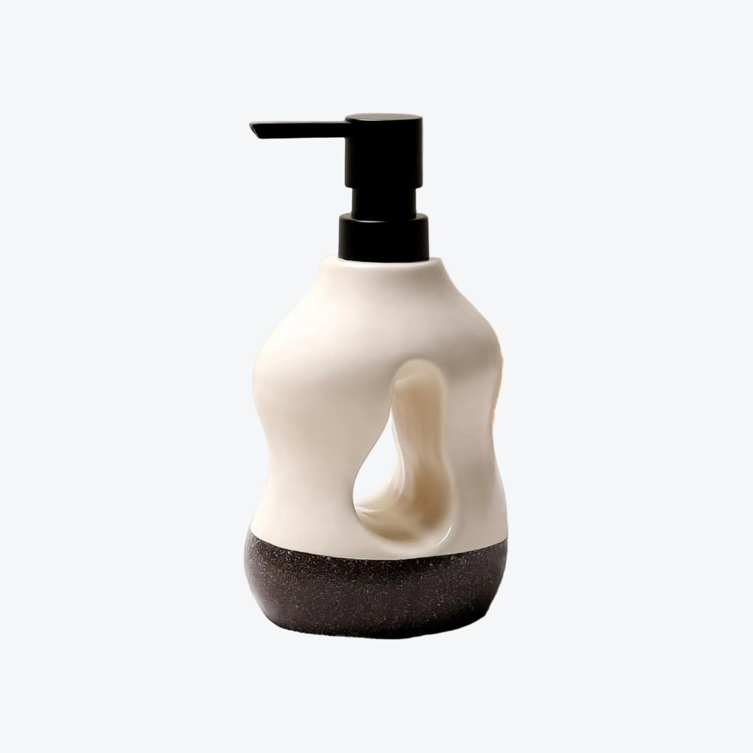BosilunLife Pebblebase 14.5 oz liquid soap dispenser in recycled eco-clay. The organic, sculptural ceramic bottle features a striking central cutout design, pairing a smooth ecru top half with a dark, speckled pebble-textured base. Finished with a matte black manual pump, it brings a serene, quiet luxury aesthetic to modern bathroom vanities.
