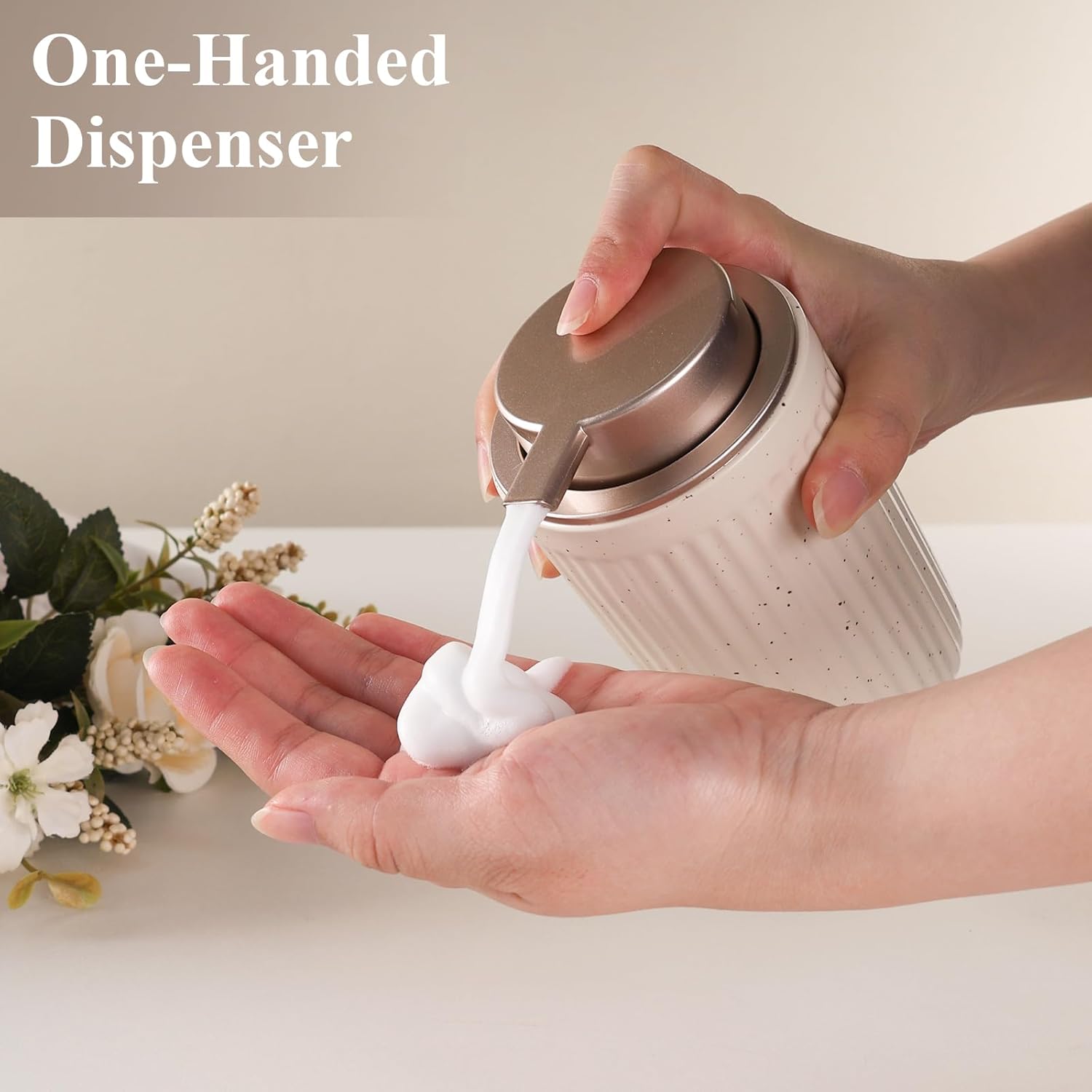 Lifestyle demonstration of the one-handed BosilunLife Pockmark soap dispenser. A person easily presses the wide champagne metallic pump with one hand to dispense a rich, white foam onto their palm, highlighting the ergonomic design of the speckled white eco-clay foaming pump.