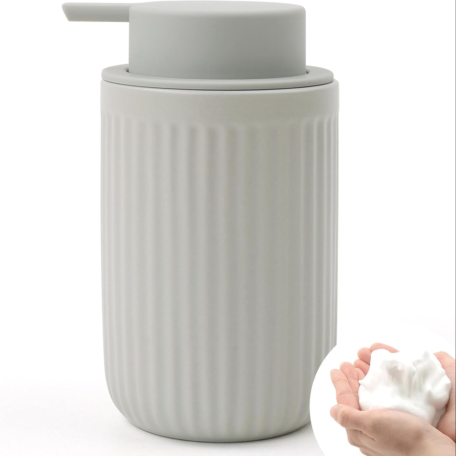 BosilunLife Pockmark 12 oz foaming soap dispenser in light grey recycled eco-clay. Features a vertically ribbed volcanic stone texture with a matching light grey matte pump and an inset showing thick white foam in a hand.