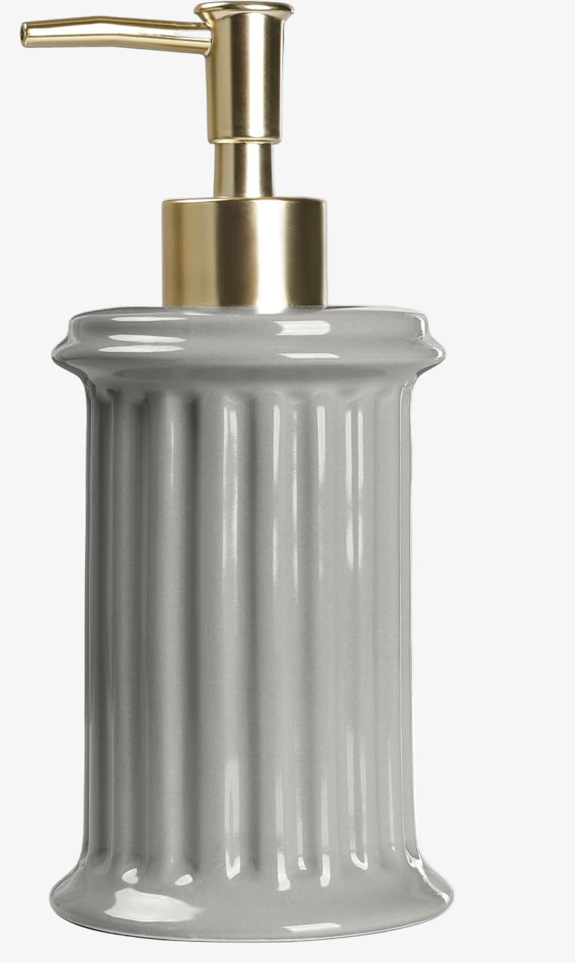 Gray soap dispenser with gold pump on a white background
