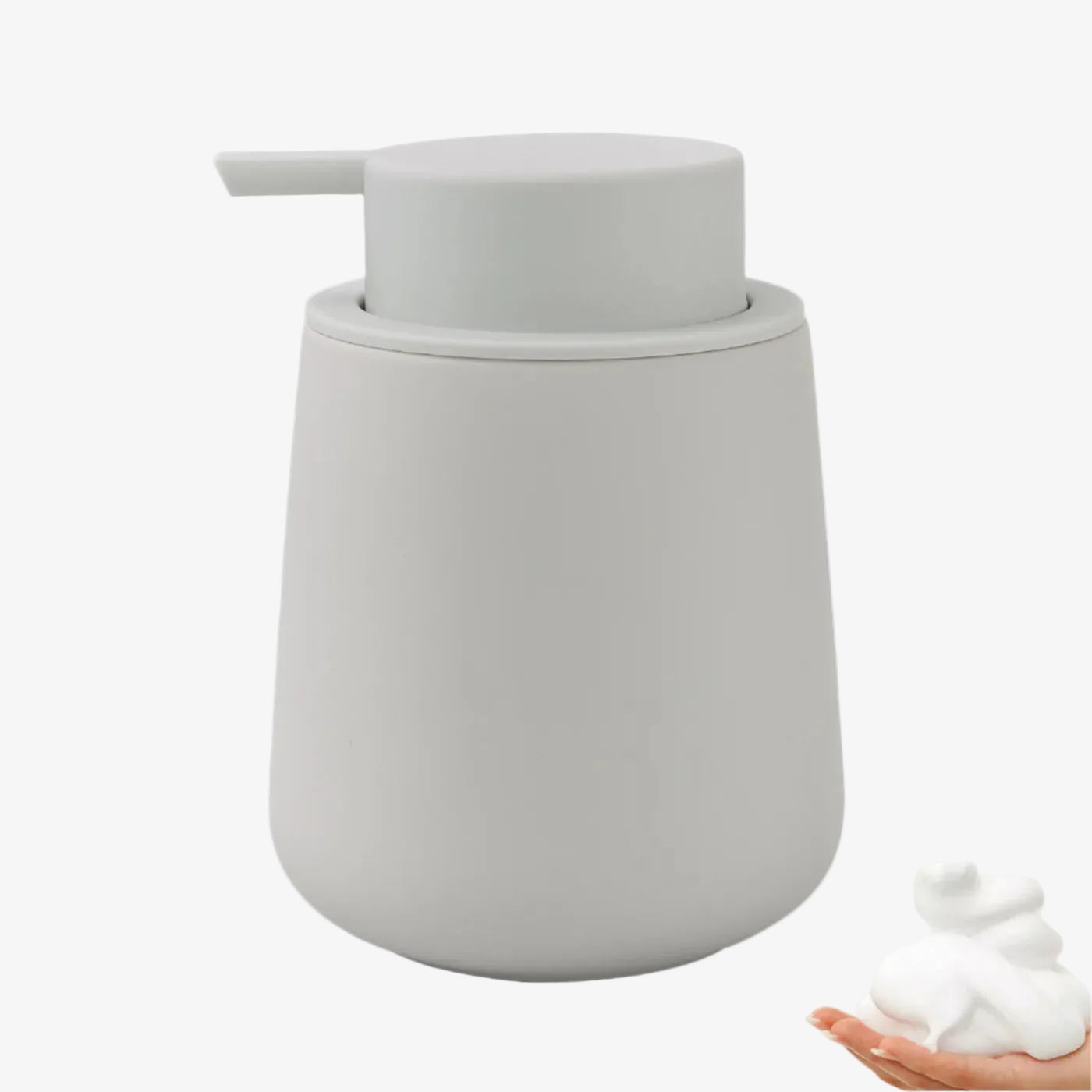 Gray soap dispenser with a small amount of soap on a white background