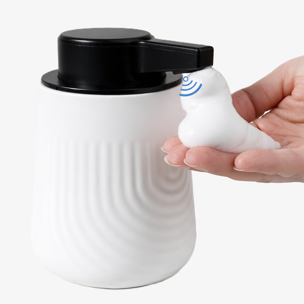BosilunLife SoftWave 10 oz white recycled eco-clay automatic soap dispenser touchlessly dispensing white foam soap into a hand.