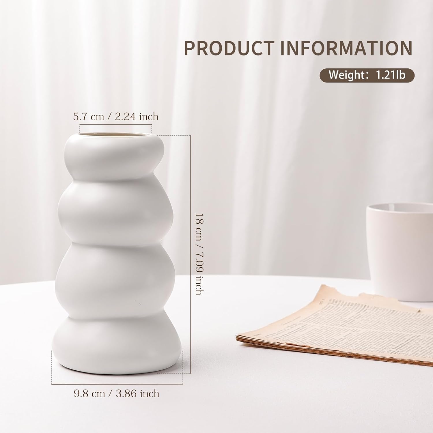 Technical dimension chart for the BosilunLife Stacked Bubble Flower Vase in matte white recycled eco-clay. Styled on a white table beside a folded newspaper, the graphic features a header reading 'PRODUCT INFORMATION' and 'Weight: 1.21lb'. Exact measurements detail the four-tier sculptural vase's footprint: 18 centimetres (7.09 inches) tall, with a 9.8 centimetre (3.86 inch) wide base and a narrow 5.7 centimetre (2.24 inch) top opening.