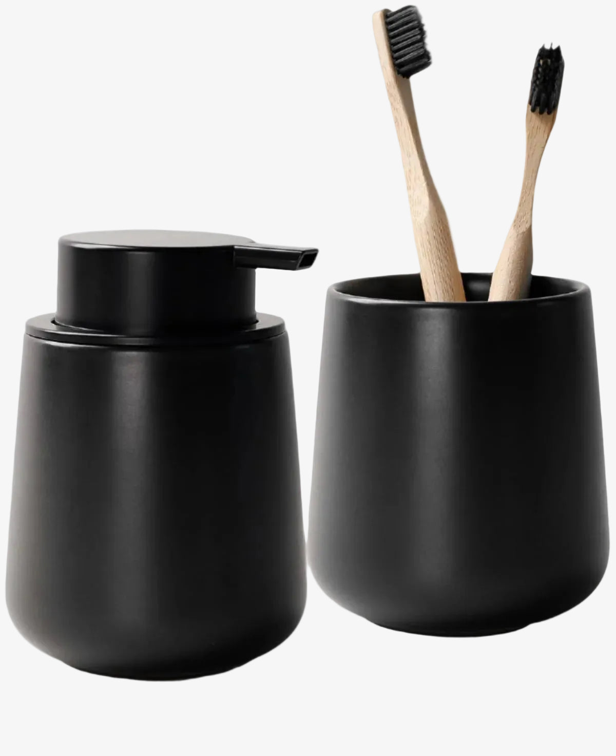Black soap dispenser and toothbrush holder with bamboo toothbrushes on a white background