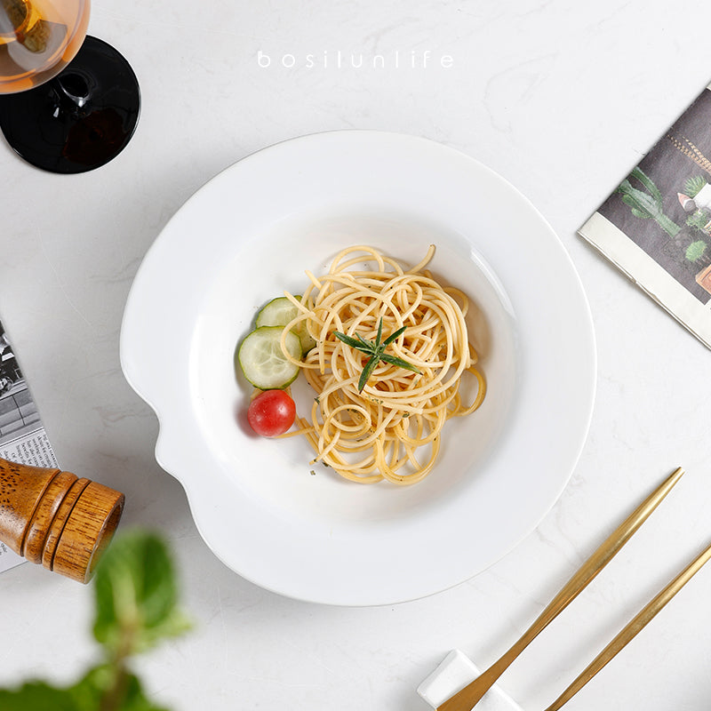 A white ceramic bowl with noodles
