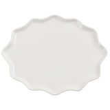 An irregularly shaped white dinner plate