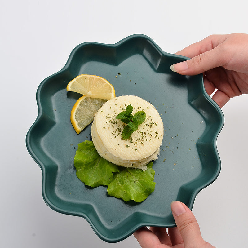 A green ceramic plate with dessert.