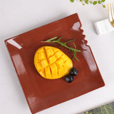 Brownish red square ceramic dinner plate with fruits