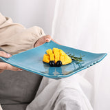 Blue ceramic square dinner plate with mango and blueberries