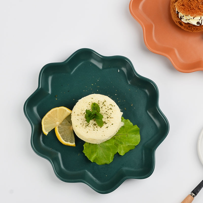 A green ceramic plate with dessert.