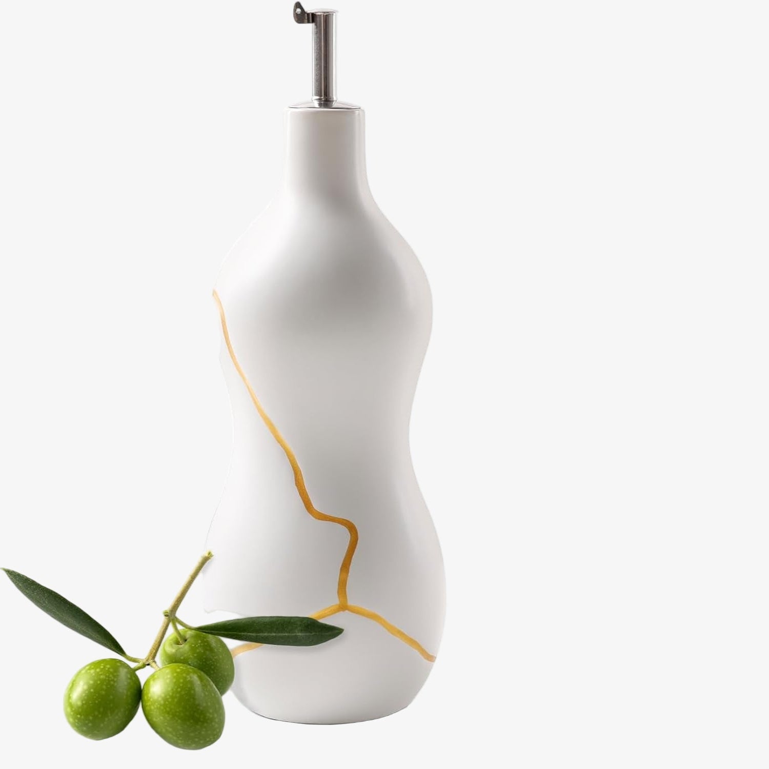 White ceramic oil bottle with gold accents and green olives on a white background