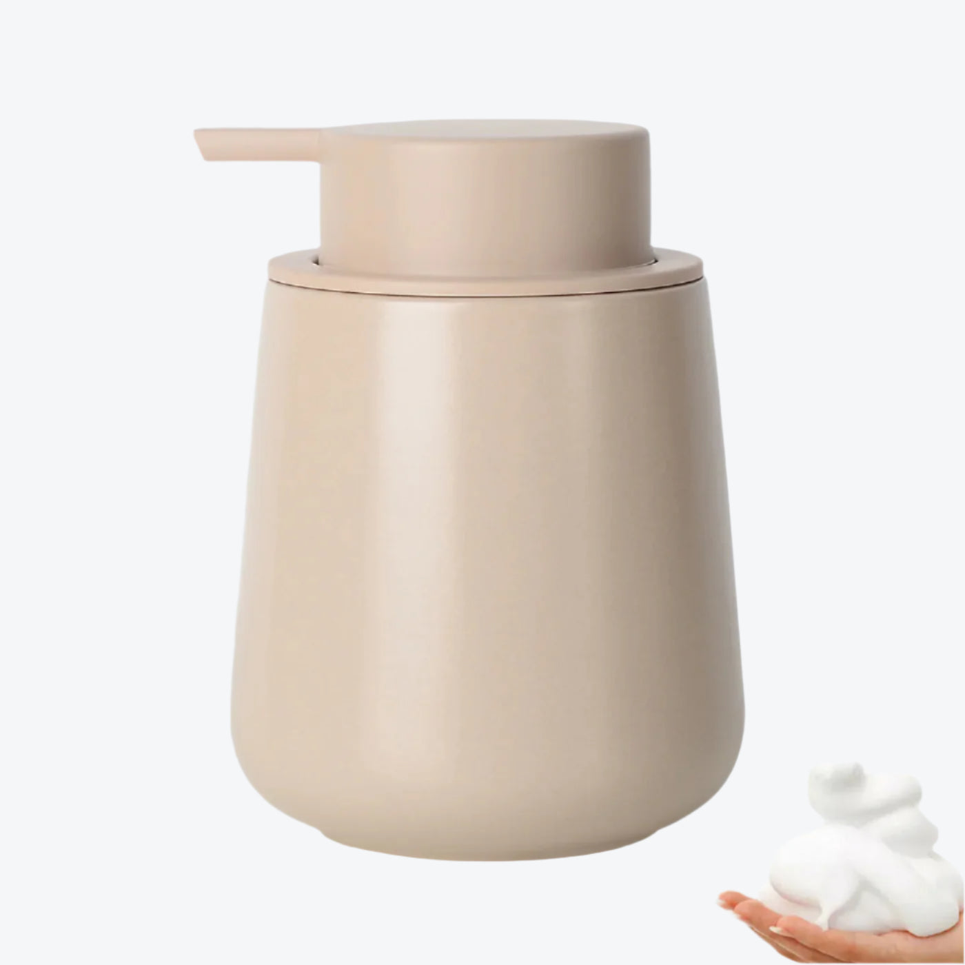 Beige soap dispenser with a small amount of foam on a white background