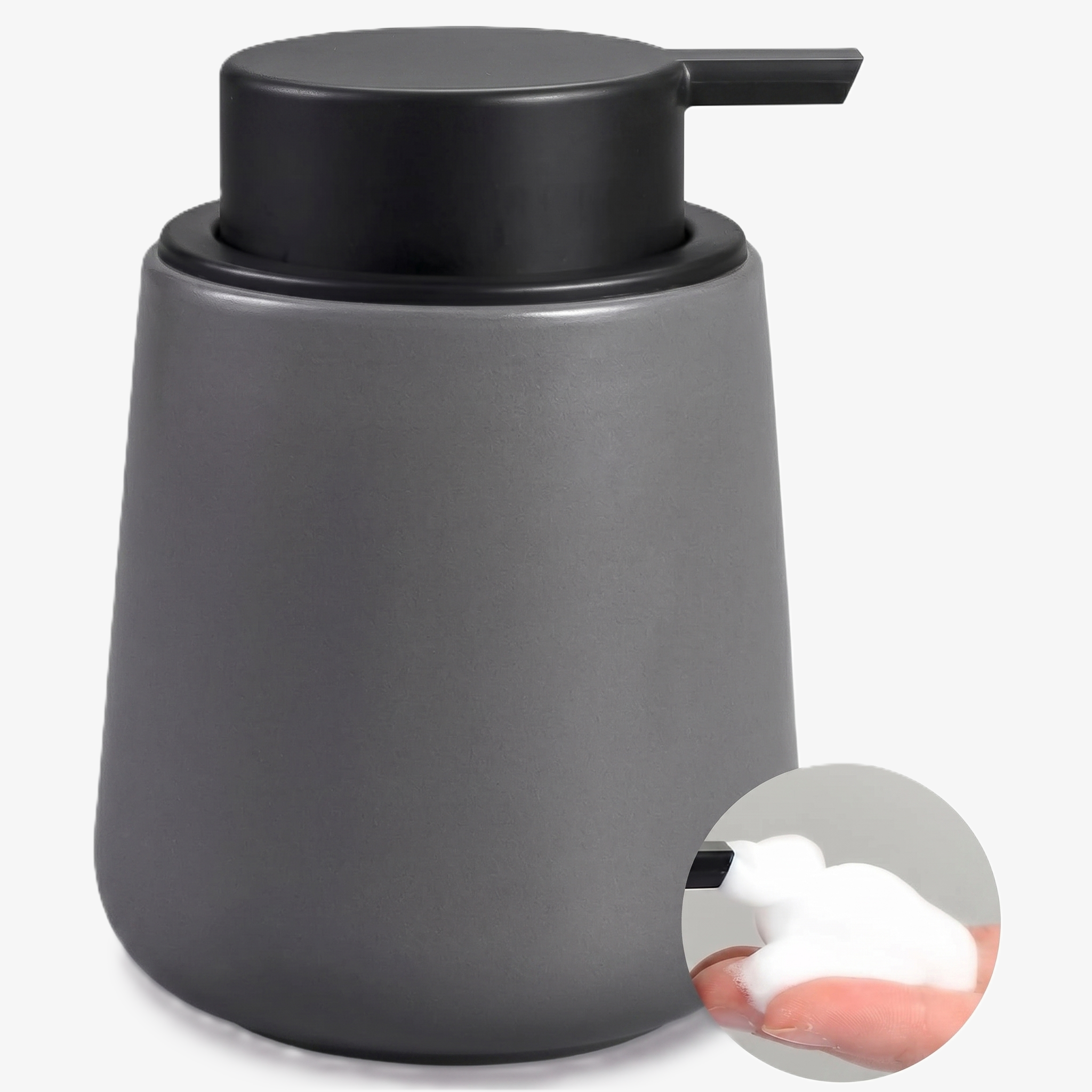 A BosilunLife eco-luxury foaming soap dispenser in a smooth charcoal grey finish, crafted from GRS-certified recycled ceramic eco-clay. The organic, rounded 12 oz (350ml) vessel is topped with a wide-head matte black pump and features an inset showing rich, velvety white foam being dispensed into a hand. This piece reflects Scandinavian functionality and a commitment to a water-saving circular economy, providing a sophisticated organisation solution for an industrial-style washroom.