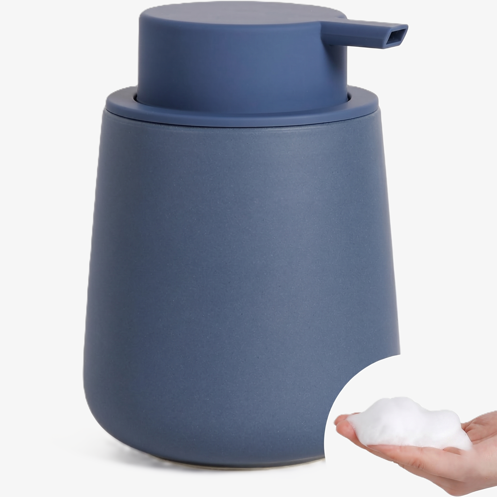 A BosilunLife eco-luxury foaming soap dispenser in a monochromatic matte navy blue finish, crafted from GRS-certified recycled ceramic eco-clay. The organic, rounded 12 oz (350ml) vessel is topped with a matching wide-head matte pump, shown with a circular inset of rich, velvety white foam in a hand. This nautical-inspired piece reflects Scandinavian functionality and a commitment to a water-saving circular economy, providing a sophisticated organisation solution for a modern washroom.
