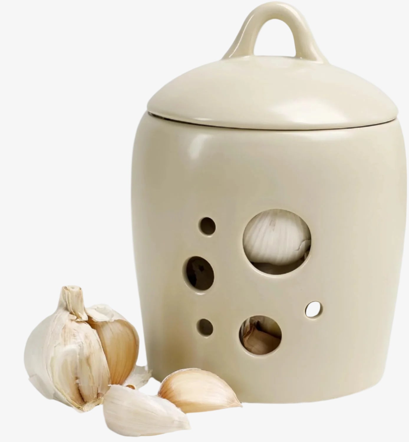 Beige ceramic jar with garlic on a white background