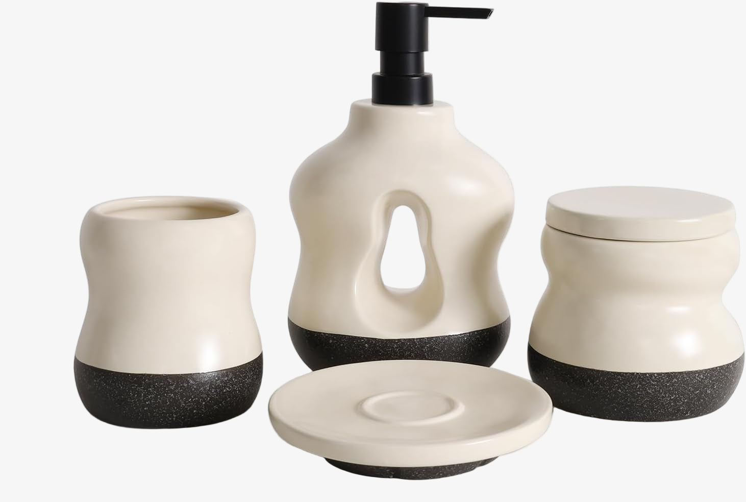 Set of four ceramic bathroom accessories with black speckled bases on a white background