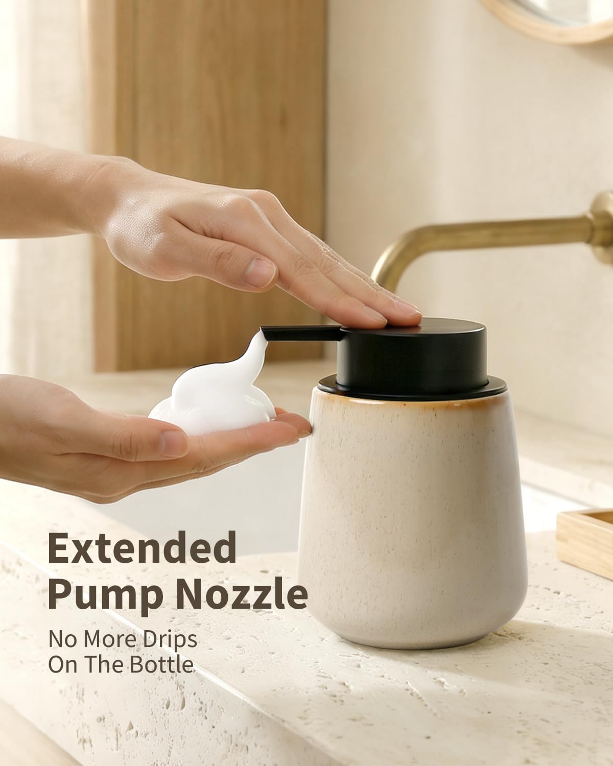 Functional lifestyle graphic for the BosilunLife 12 oz foaming soap dispenser in speckled Greige, titled 'Extended Pump Nozzle'. Hands are shown operating the matte black pump to dispense rich white foam, demonstrating the 'No More Drips On The Bottle' design. Crafted from GRS-certified recycled eco-clay, this organic vessel is styled in a warm, modern washroom with brass fixtures, reflecting Scandinavian functionality and a commitment to a sustainable circular economy.
