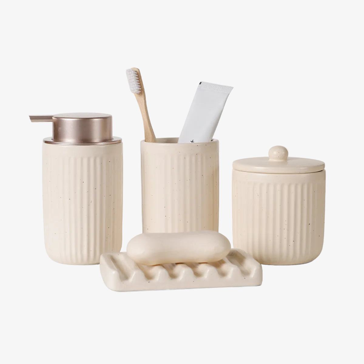 Beige ceramic bathroom set with toothbrush, soap, and container on a white background