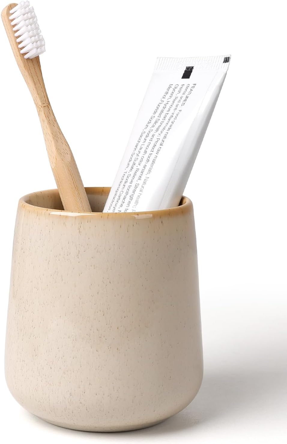BosilunLife eco-luxury bathroom tumbler and toothbrush holder, crafted from GRS-certified recycled ceramic eco-clay. The organic silhouette features a speckled ecru finish with a warm tan-glazed rim, blending Scandinavian functionality with the quiet balance of nature. Styled with a sustainable bamboo toothbrush and white toothpaste tube, it showcases intentional design and a commitment to the circular economy and planetary responsibility.