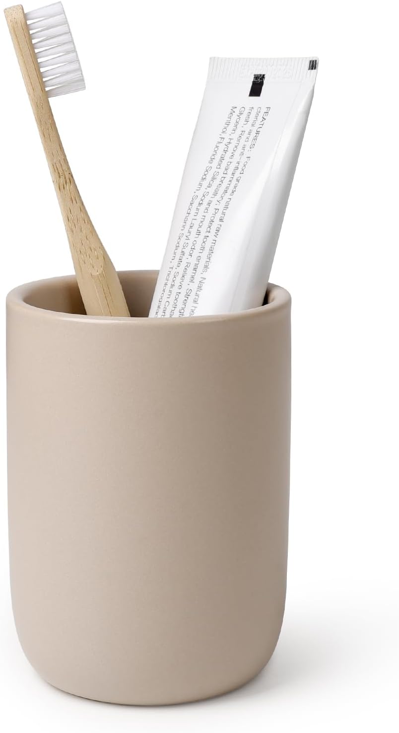 BosilunLife eco-luxury bathroom tumbler and toothbrush holder in a smooth matte tan finish. Crafted from GRS-certified recycled ceramic eco-clay, the organic rounded silhouette balances Scandinavian functionality with the quiet harmony of nature. Styled with a sustainable bamboo toothbrush and white toothpaste tube, it represents intentional design and a commitment to the circular economy and a sustainable world.