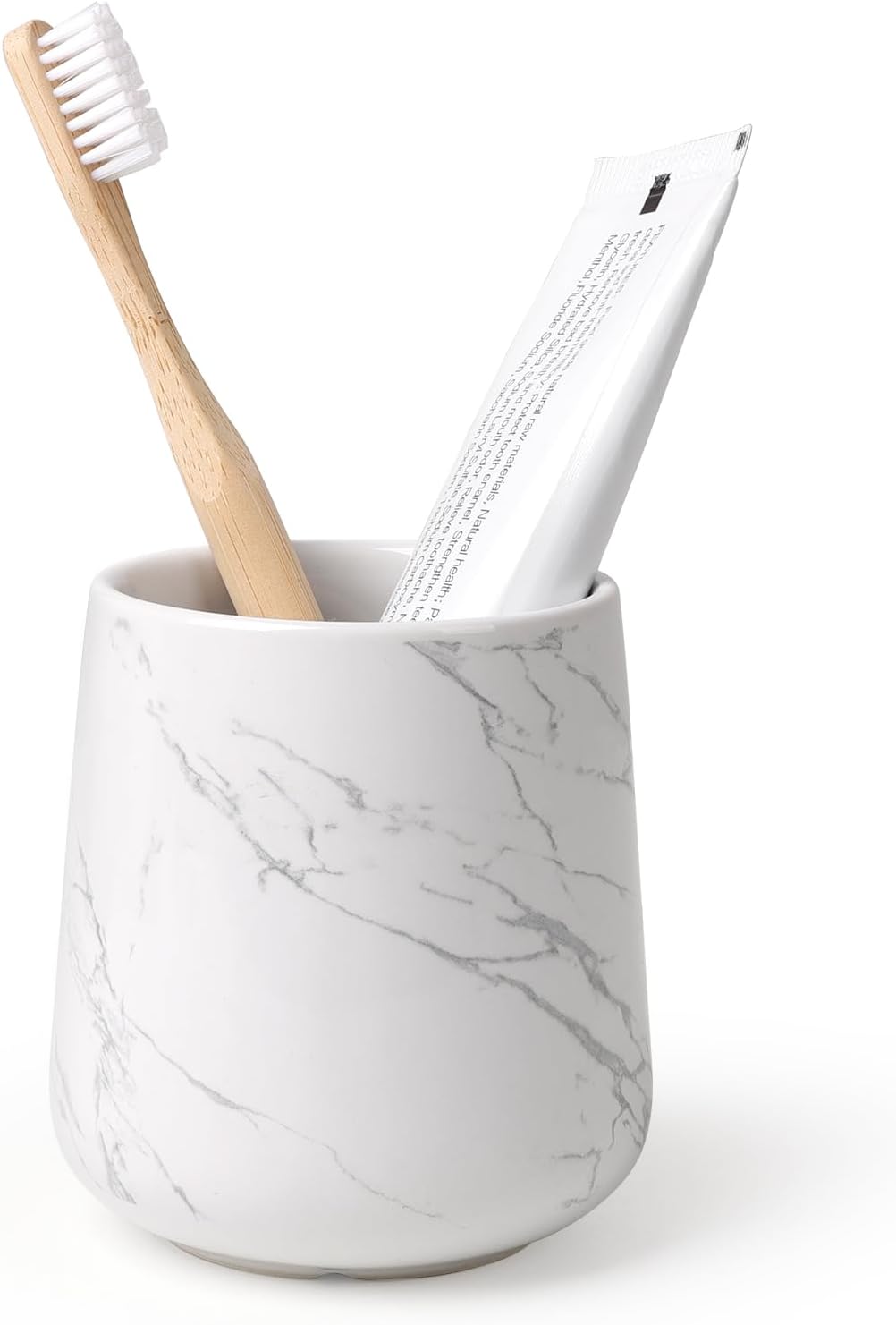 BosilunLife eco-luxury bathroom tumbler and toothbrush holder in a white marble-effect finish. Crafted from GRS-certified recycled ceramic eco-clay, the piece features delicate grey veining that balances Scandinavian functionality with the quiet harmony of nature. Styled with a sustainable bamboo toothbrush and white toothpaste tube, it showcases intentional design and a commitment to the circular economy and planetary responsibility.